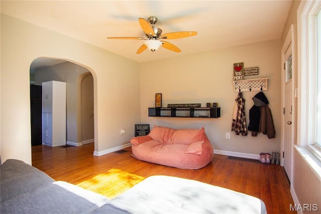 108 Tomlinson St, East Alton, IL 62024 - living room with arched walkways, wood finished floors, and a ceiling fan