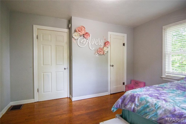 108 Tomlinson St, East Alton, IL 62024 - bedroom with wood finished floors and multiple windows