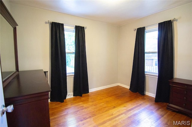 108 Tomlinson St, East Alton, IL 62024 - empty room with healthy amount of natural light and light wood-style flooring