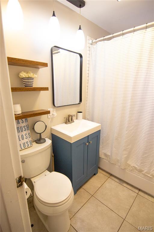 108 Tomlinson St, East Alton, IL 62024 - bathroom featuring vanity, tile patterned flooring, and shower / bath combination with curtain
