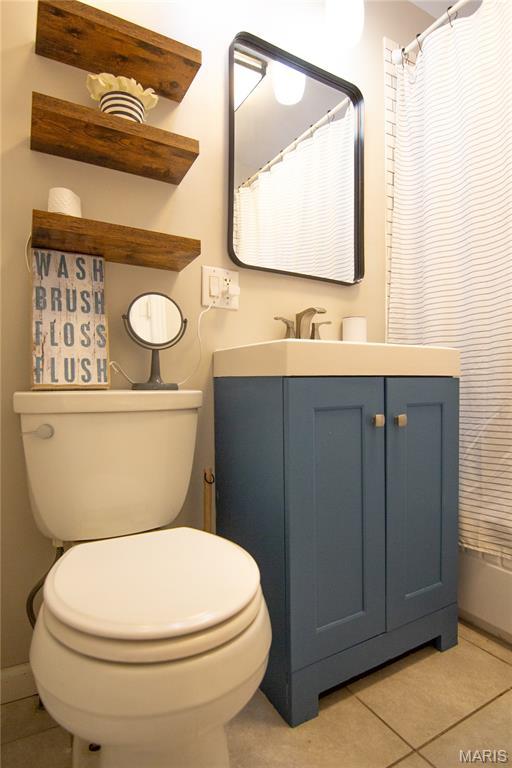108 Tomlinson St, East Alton, IL 62024 - full bath with tile patterned flooring, vanity, and a shower with curtain