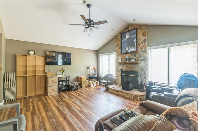 2629 Seminole Rd, Cuba, MO 65453 - living area featuring wood finished floors, ceiling fan, a stone fireplace, and high vaulted ceiling