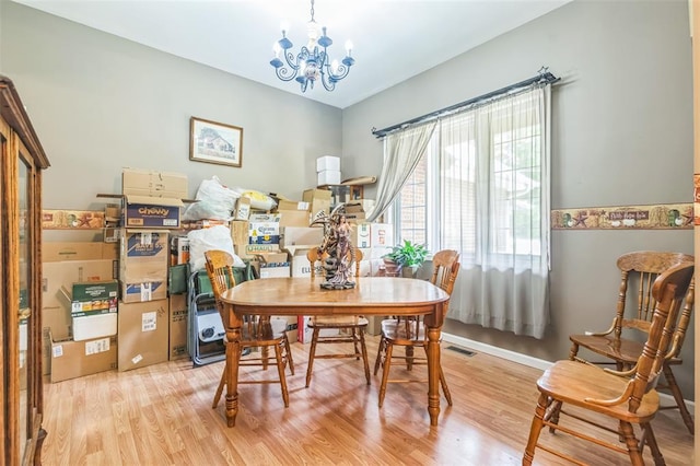 2629 Seminole Rd, Cuba, MO 65453 - dining space with light wood-style flooring, a chandelier, and baseboards