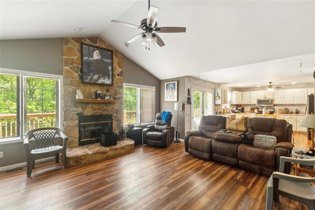 2629 Seminole Rd, Cuba, MO 65453 - living area with a ceiling fan, vaulted ceiling, wood finished floors, and a stone fireplace