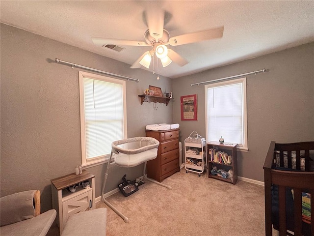 711 N Lindell St, Vandalia, MO 63382 - bedroom with light colored carpet, ceiling fan, baseboards, and a textured ceiling