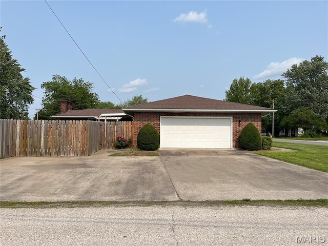 1319 W Main St, Bowling Green, MO 63334 - view of property exterior featuring a garage, brick siding, and driveway