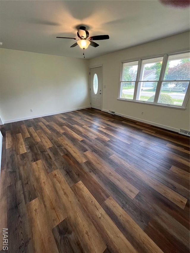 1319 W Main St, Bowling Green, MO 63334 - empty room with dark wood-style flooring, a ceiling fan, and baseboards