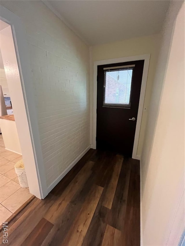 1319 W Main St, Bowling Green, MO 63334 - hall featuring wood finished floors, brick wall, and baseboards
