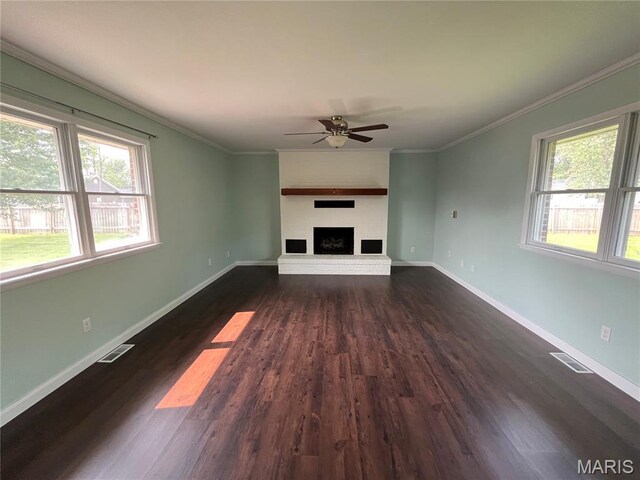 1319 W Main St, Bowling Green, MO 63334 - unfurnished living room featuring ceiling fan, dark wood-style flooring, crown molding, a fireplace with raised hearth, and baseboards