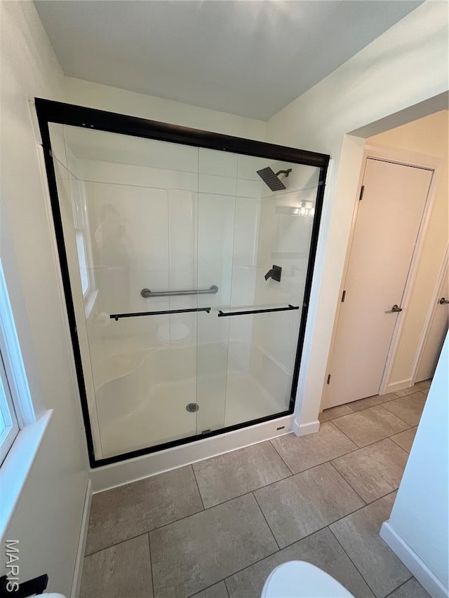 1319 W Main St, Bowling Green, MO 63334 - bathroom with a stall shower, toilet, and baseboards