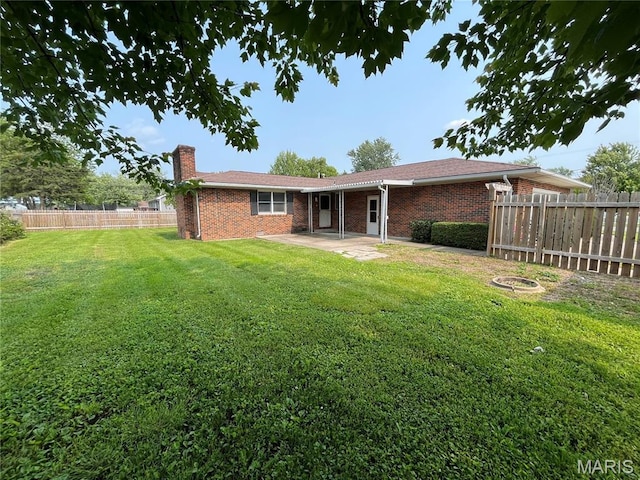 1319 W Main St, Bowling Green, MO 63334 - back of property featuring brick siding, a chimney, and a patio area