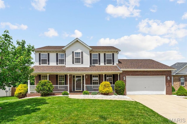 2711 Cascade Lake Dr, Shiloh, IL 62221 - colonial home with driveway, an attached garage, and brick siding