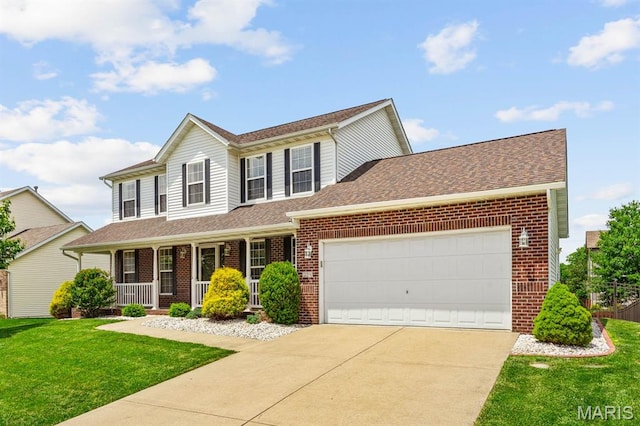 2711 Cascade Lake Dr, Shiloh, IL 62221 - view of front of home with brick siding, concrete driveway, an attached garage, and covered porch