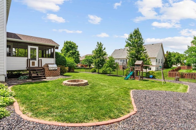 2711 Cascade Lake Dr, Shiloh, IL 62221 - view of yard with an outdoor fire pit, a sunroom, and a playground