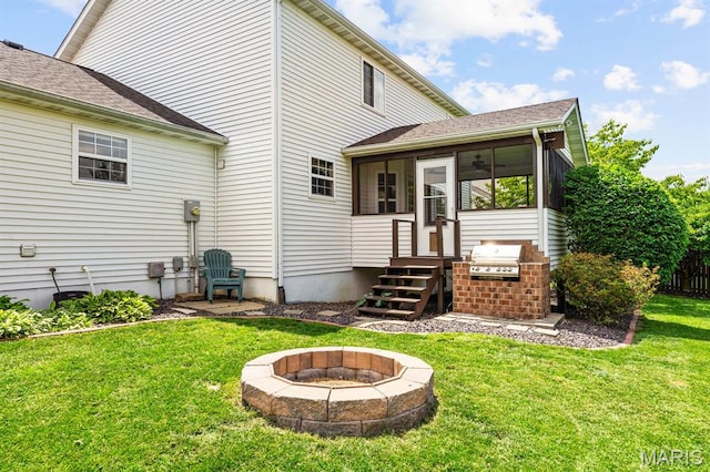 2711 Cascade Lake Dr, Shiloh, IL 62221 - back of house with a fire pit, a lawn, and a sunroom