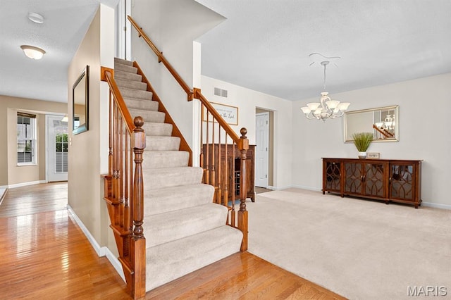 2711 Cascade Lake Dr, Shiloh, IL 62221 - stairs featuring a chandelier, wood finished floors, and baseboards