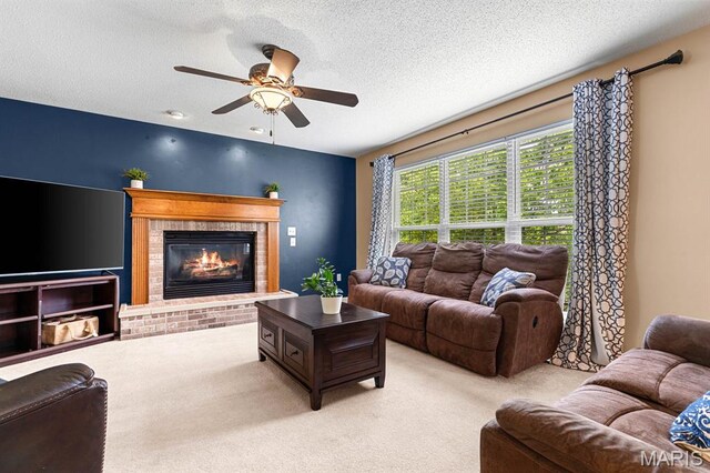 2711 Cascade Lake Dr, Shiloh, IL 62221 - living area with carpet, a ceiling fan, a brick fireplace, and a textured ceiling