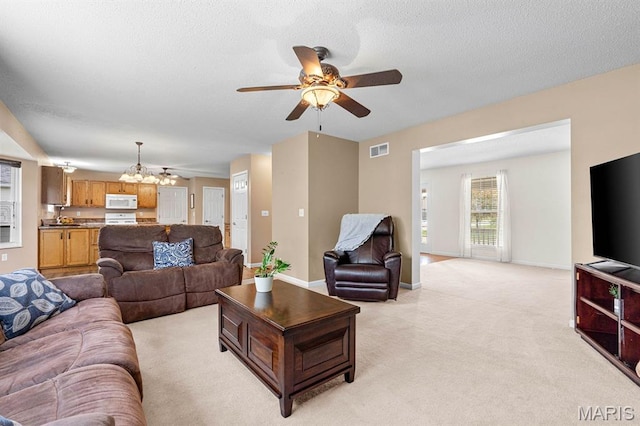 2711 Cascade Lake Dr, Shiloh, IL 62221 - living room with ceiling fan, light carpet, a chandelier, baseboards, and a textured ceiling