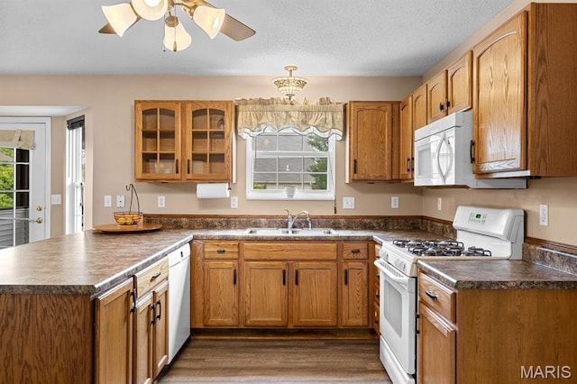 2711 Cascade Lake Dr, Shiloh, IL 62221 - kitchen featuring white appliances, dark countertops, a peninsula, a sink, and brown cabinetry