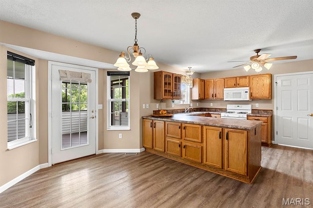 2711 Cascade Lake Dr, Shiloh, IL 62221 - kitchen featuring white appliances, dark wood finished floors, brown cabinetry, dark countertops, and a textured ceiling