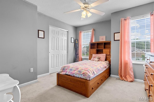 2711 Cascade Lake Dr, Shiloh, IL 62221 - bedroom featuring light colored carpet, a textured ceiling, baseboards, a closet, and a ceiling fan