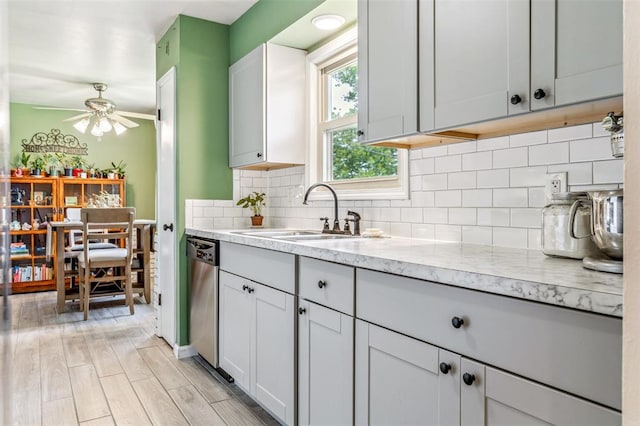 330 Mont Divier Dr, Bonne Terre, MO 63628 - kitchen featuring a sink, a ceiling fan, stainless steel dishwasher, tasteful backsplash, and light stone countertops