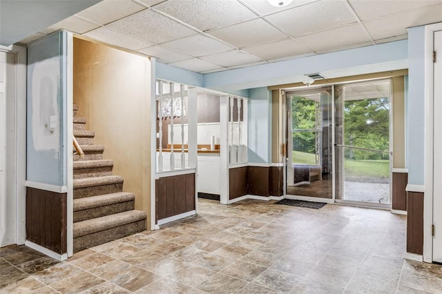 330 Mont Divier Dr, Bonne Terre, MO 63628 - unfurnished room with a drop ceiling, plenty of natural light, stairs, stone finish floors, and baseboards