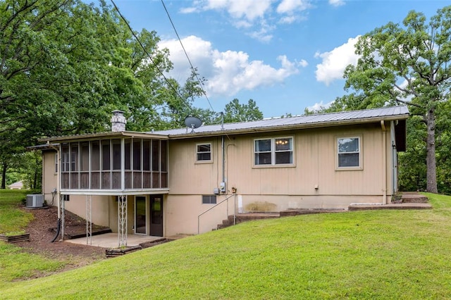 330 Mont Divier Dr, Bonne Terre, MO 63628 - back of house featuring a patio area, a sunroom, a chimney, and a yard