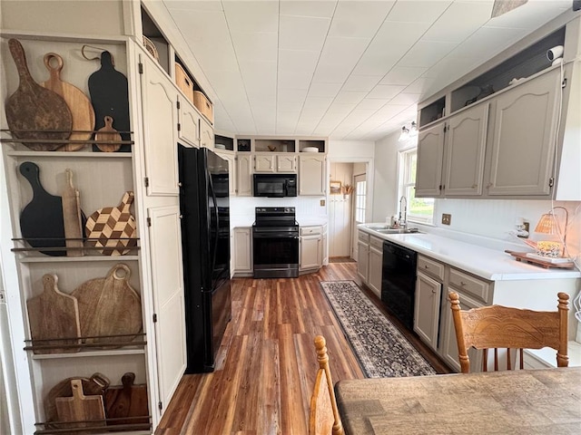 517 W Olive St, Palmyra, MO 63461 - kitchen with black appliances, wood finished floors, a sink, and light countertops