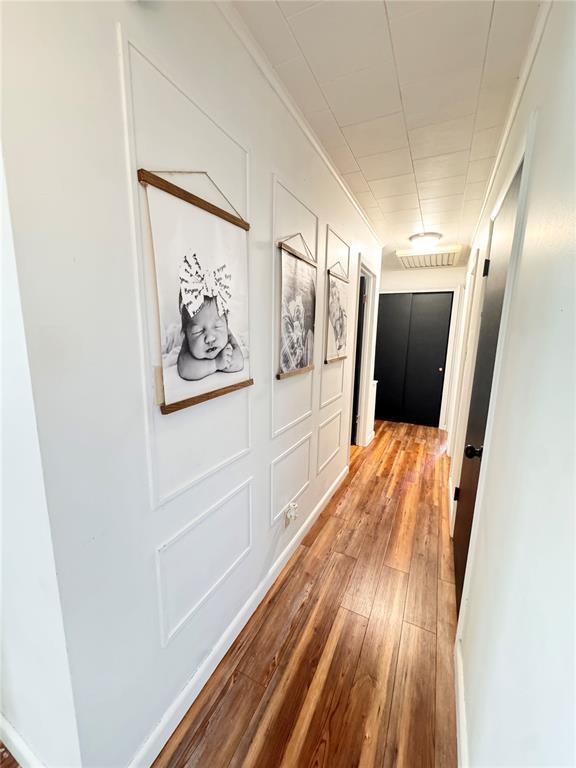517 W Olive St, Palmyra, MO 63461 - corridor featuring wood-type flooring and crown molding