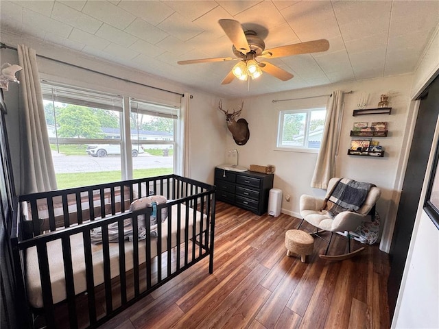517 W Olive St, Palmyra, MO 63461 - bedroom with wood finished floors, a ceiling fan, and baseboards