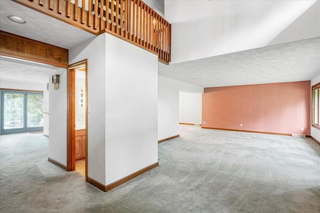 513 Matthews Ln, Waterloo, IL 62298 - unfurnished living room featuring carpet, baseboards, and a textured ceiling