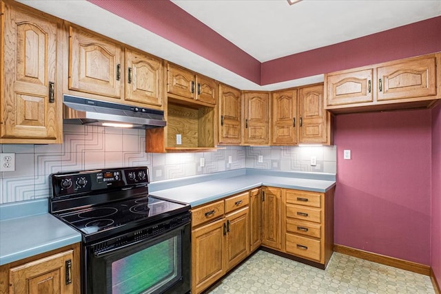 513 Matthews Ln, Waterloo, IL 62298 - kitchen with black electric range oven, under cabinet range hood, light flooring, decorative backsplash, and light countertops