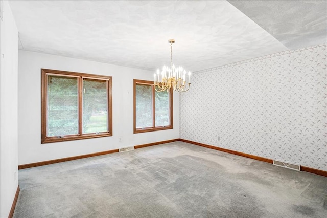 513 Matthews Ln, Waterloo, IL 62298 - unfurnished room with plenty of natural light, a chandelier, baseboards, carpet flooring, and wallpapered walls