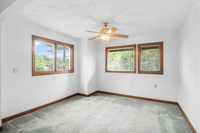 513 Matthews Ln, Waterloo, IL 62298 - carpeted empty room with healthy amount of natural light, ceiling fan, baseboards, and a textured ceiling