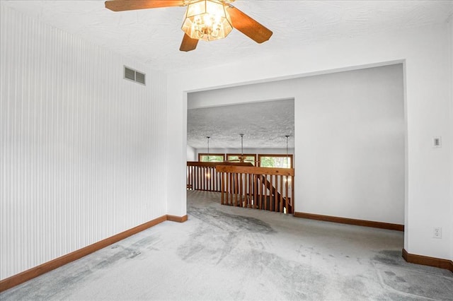 513 Matthews Ln, Waterloo, IL 62298 - carpeted empty room featuring a textured ceiling, a ceiling fan, and baseboards