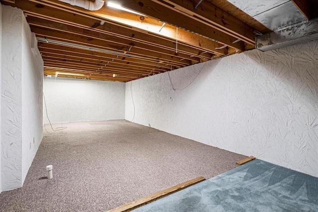 513 Matthews Ln, Waterloo, IL 62298 - finished below grade area with a textured wall and carpet flooring