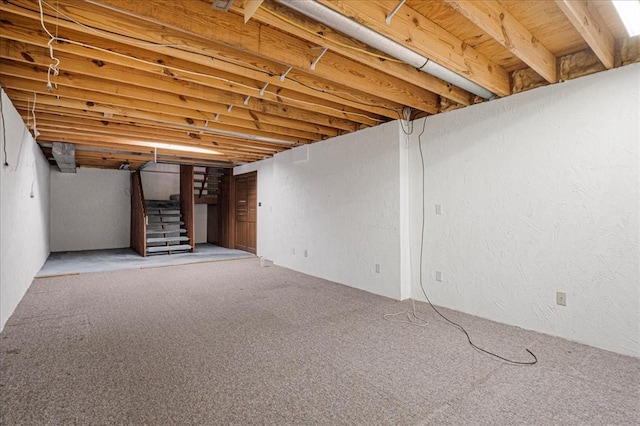 513 Matthews Ln, Waterloo, IL 62298 - finished basement featuring stairs, carpet flooring, and a textured wall