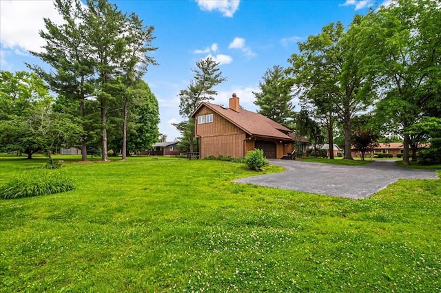 513 Matthews Ln, Waterloo, IL 62298 - view of green lawn with asphalt driveway and an attached garage