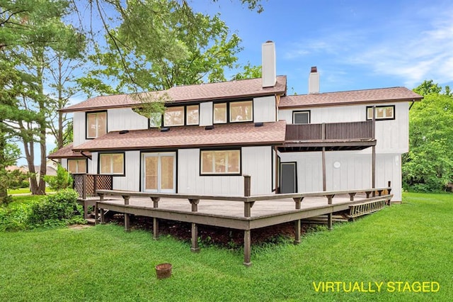 513 Matthews Ln, Waterloo, IL 62298 - back of property with a balcony, a yard, a chimney, a wooden deck, and roof with shingles