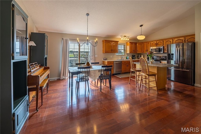 781 N W Ln, Jackson, MO 63755 - dining room featuring a chandelier, dark wood finished floors, vaulted ceiling, baseboards, and a textured ceiling