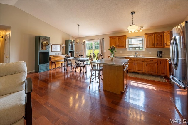 781 N W Ln, Jackson, MO 63755 - kitchen with a sink, freestanding refrigerator, brown cabinetry, dark wood finished floors, and vaulted ceiling