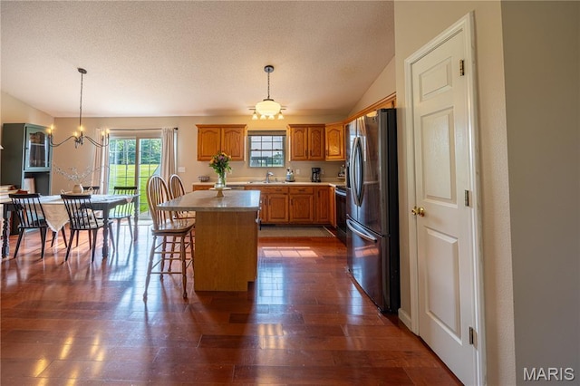 781 N W Ln, Jackson, MO 63755 - kitchen with stainless steel refrigerator with ice dispenser, a sink, a kitchen island, dark wood finished floors, and brown cabinetry