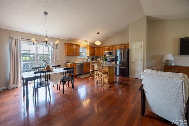 781 N W Ln, Jackson, MO 63755 - dining area featuring a chandelier, dark wood-style floors, and vaulted ceiling