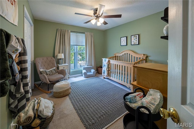781 N W Ln, Jackson, MO 63755 - bedroom with carpet flooring, ceiling fan, a textured ceiling, and a nursery area