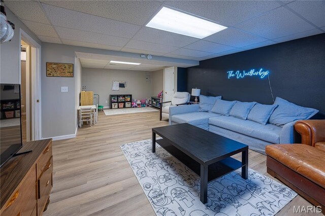 781 N W Ln, Jackson, MO 63755 - living room featuring a paneled ceiling, light wood-type flooring, and baseboards