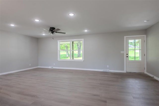 405 Julie Ln, Holts Summit, MO 65043 - empty room with plenty of natural light, baseboards, recessed lighting, ceiling fan, and wood finished floors