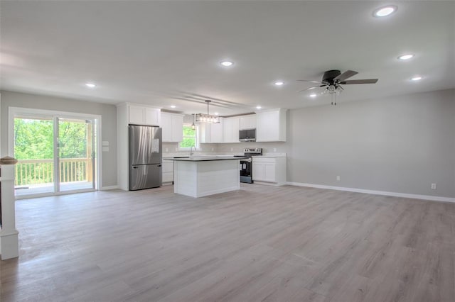 405 Julie Ln, Holts Summit, MO 65043 - kitchen with appliances with stainless steel finishes, open floor plan, baseboards, recessed lighting, and white cabinets