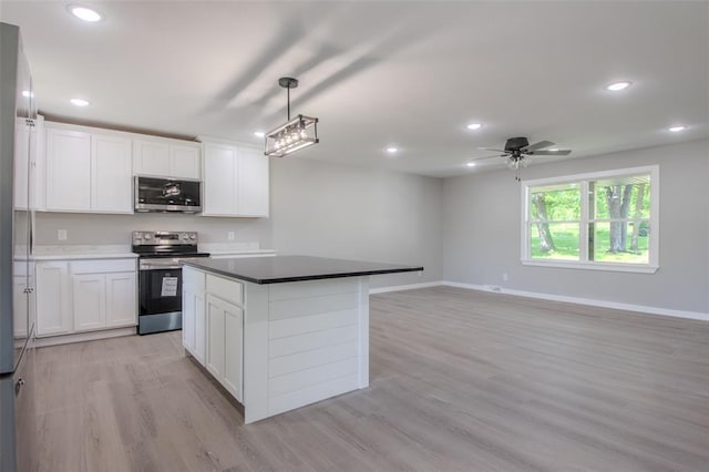 405 Julie Ln, Holts Summit, MO 65043 - kitchen with appliances with stainless steel finishes, recessed lighting, baseboards, light wood-type flooring, and white cabinetry