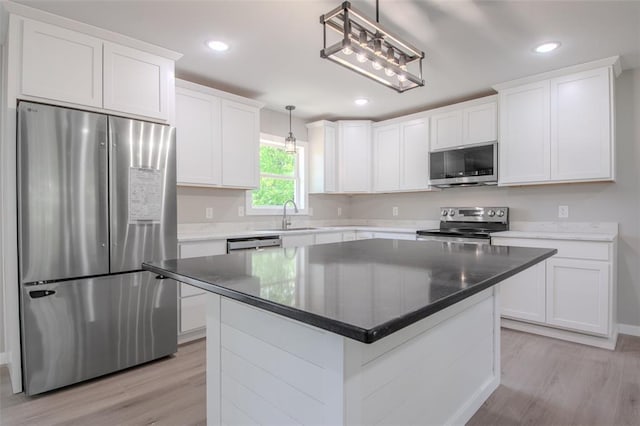 405 Julie Ln, Holts Summit, MO 65043 - kitchen featuring appliances with stainless steel finishes, light wood finished floors, white cabinetry, a sink, and recessed lighting